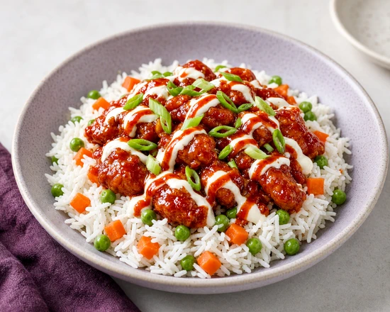 Gochujang chicken rice bowl with peas, carrots and sauce drizzles